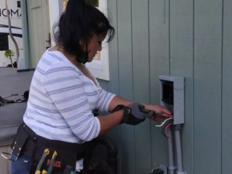 Licensed electrician wiring an exterior subpanel in Porter